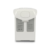 White drone battery pack with warning labels and connector pins