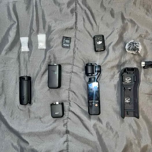 Handheld gimbal action camera kit with multiple accessories, including charging case and handle