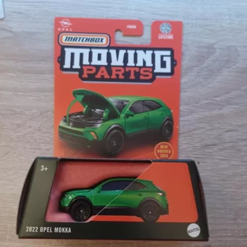 Green die-cast toy car with moving parts in retail box, Opel Mokka 2022.