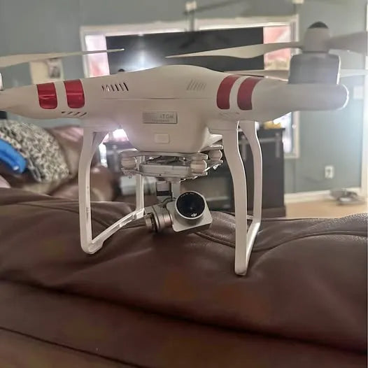 White quadcopter drone with front camera gimbal and red side accents