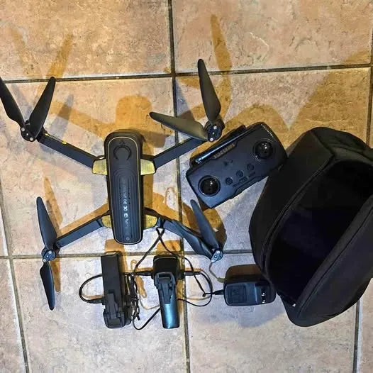 Compact foldable drone with controller, two batteries, and protective case