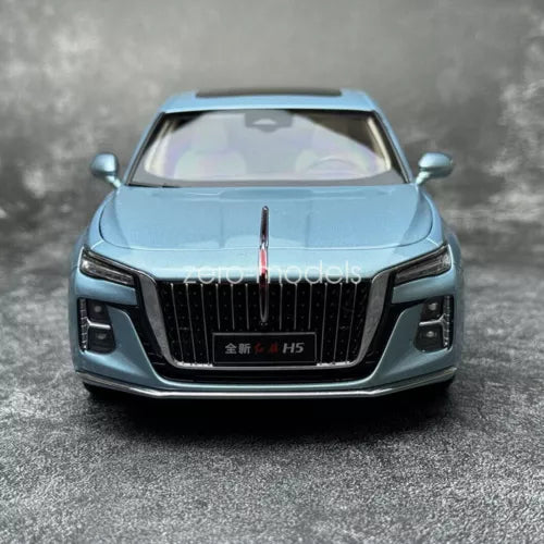 Blue 1:18 diecast sedan model car, front view with grille and headlights