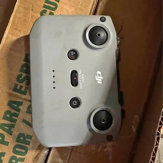 DJI drone controller, gray back panel with two joysticks and buttons