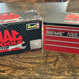 Red and black diecast NASCAR car model in open box, Revell logo visible