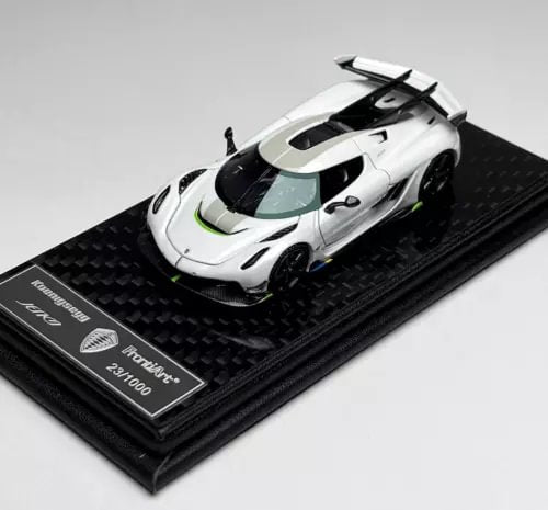White racing diecast car model with clear windshield on black display base