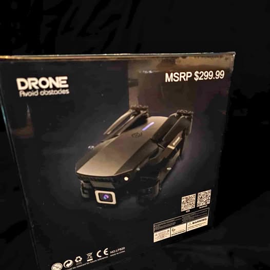 Foldable drone in retail box, front view with controller-style details