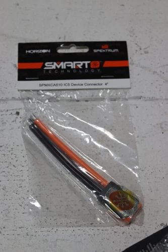 Drone cable connector in clear packaging, orange-and-black wires with metal pins