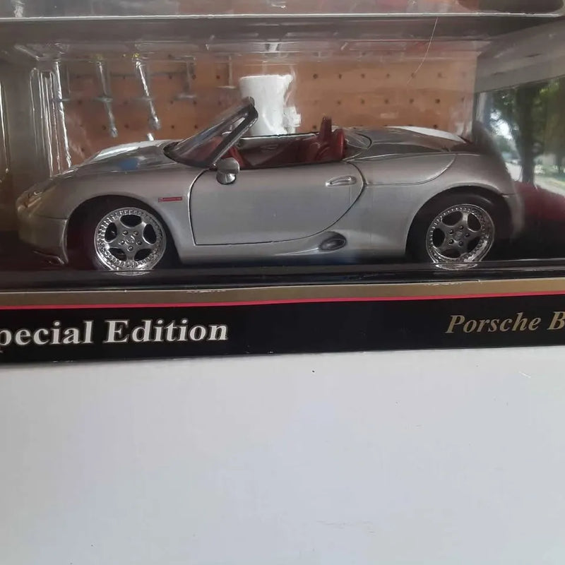 Silver diecast sports car model with rear spoiler and detailed wheels