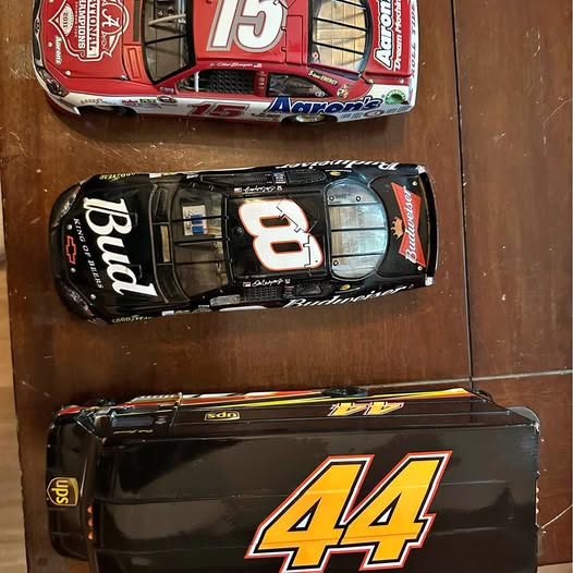 Diecast racing package car model, black with 44 numeral and yellow stripe accents