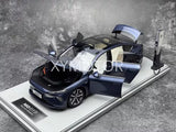 1:18 NIO ET7 diecast model car, blue with open doors, on display base
