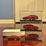Red Model 3 diecast car in clear display box, side view