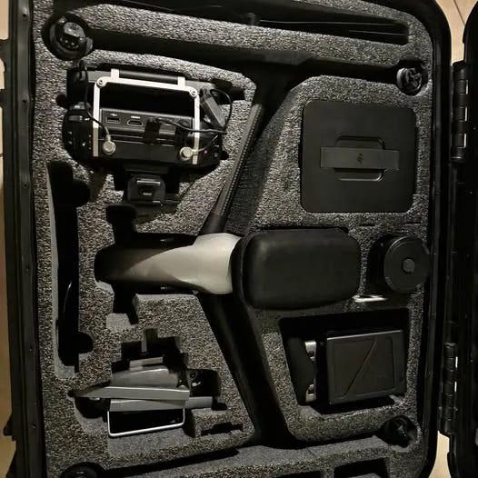 Drone in molded foam carrying case with accessories and controller mount