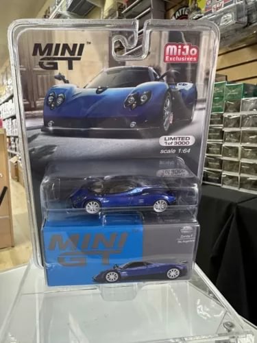 Blue diecast sports car model in clear blister pack, Mini GT 1/64 scale