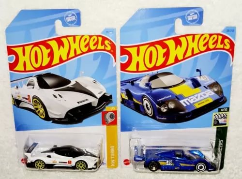 Diecast race cars blister packs: white Pagani Zonda R and blue Mazda 787B