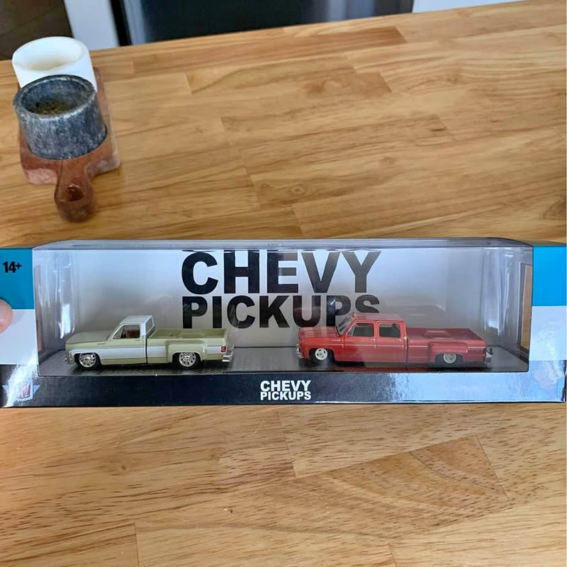 M2 Machines diecast Chevy pickup truck set in retail box, white and red trucks