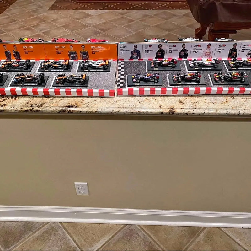 Diecast vehicle display set with multiple race cars on checkered orange shelf