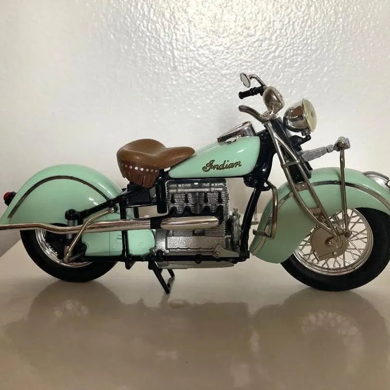 Mint green diecast motorcycle model with brown seat and Indian logo, side view