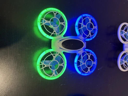 Kids RC quadcopter drone with four LED-lit propeller guards in green and blue
