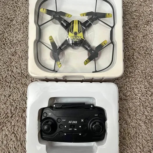 Small quadcopter drone with controller in open protective case
