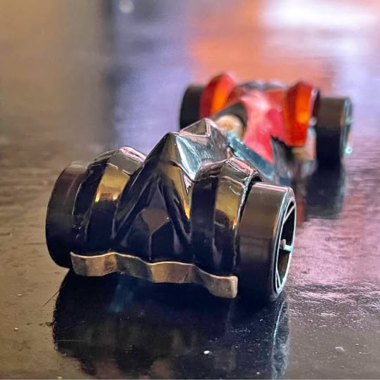 Hotwheels die-cast toy ship with chrome body and red flame decals