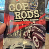 Diecast police cruiser car in Hot Wheels blister packaging, dark maroon and white