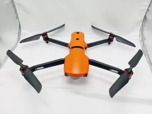 Orange and black quadcopter drone with four propellers