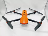 Orange and black quadcopter drone with four propellers