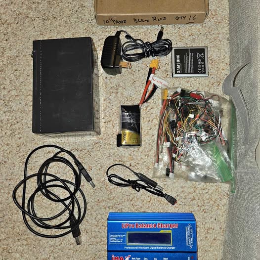 Drone parts kit with wiring harness, charger, and control cables in a bundle