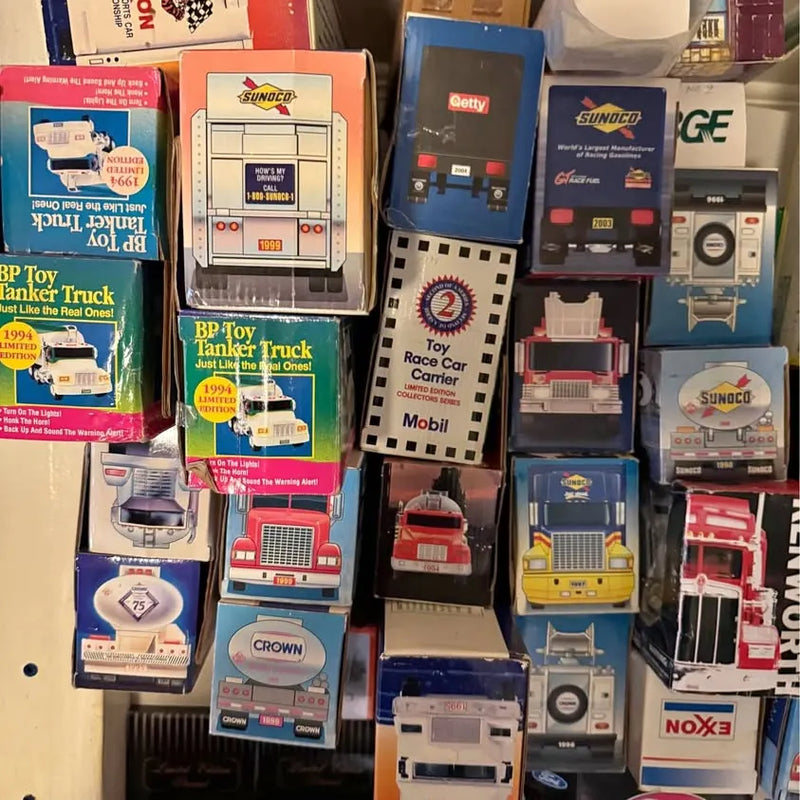 Diecast toy truck set in retail boxes, multiple colored trucks and trailers