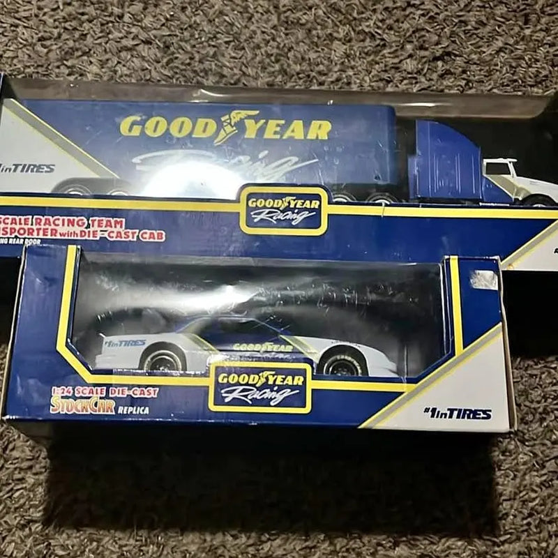 Blue Goodyear die-cast racing car with trailer, front view, scale model