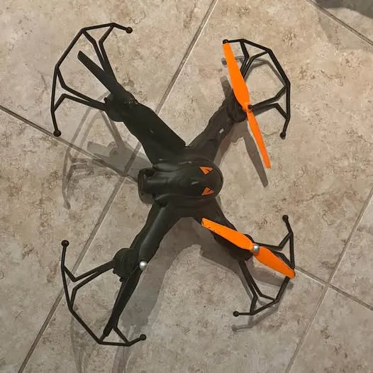 Vivitar quadcopter drone with orange prop guards and black frame