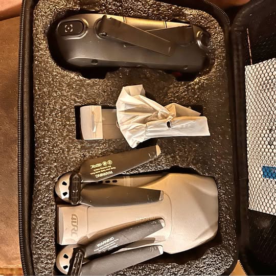 Foam-lined protective case with folding quadcopter drone and accessories