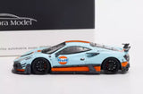 Blue sports diecast car model with black wheels and orange front splitter detail