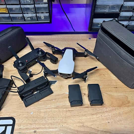 DJI Mavic Air drone with remote controller, batteries, and landing accessories
