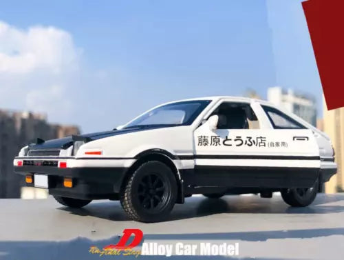 White alloy diecast model car, side view with black wheels and rear spoiler