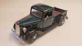 Diecast 1937 Ford pickup truck model, dark green and black cab with silver grille
