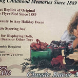 Green diecast sled with red top trim and bundled holiday decorations
