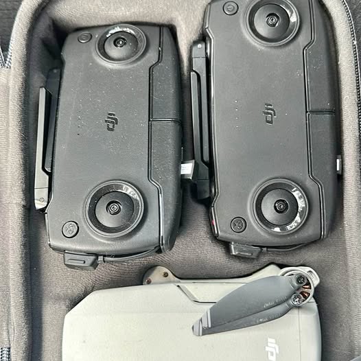 Gray remote controllers in protective case, joysticks and buttons visible