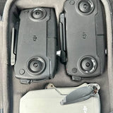 Gray remote controllers in protective case, joysticks and buttons visible