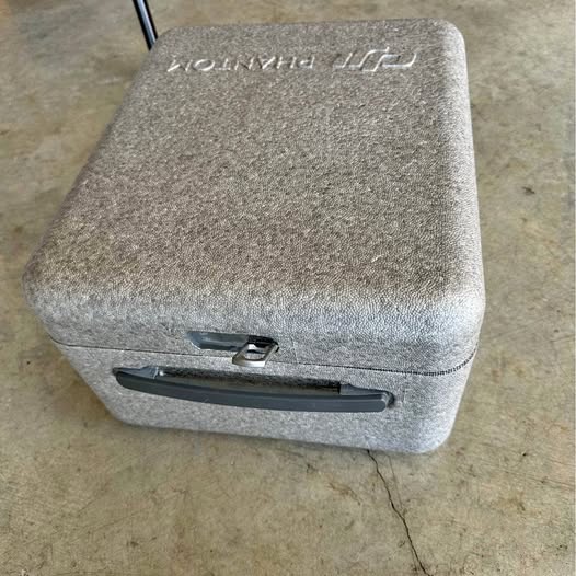 Gray textured hard drone carrying case with top handle and latch