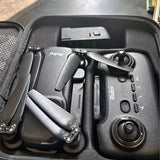 Drone and remote controller in black protective case, visible joysticks and buttons