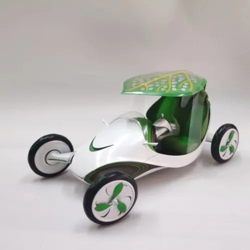 White and dark green diecast concept car model with green canopy, four wheels, motion style