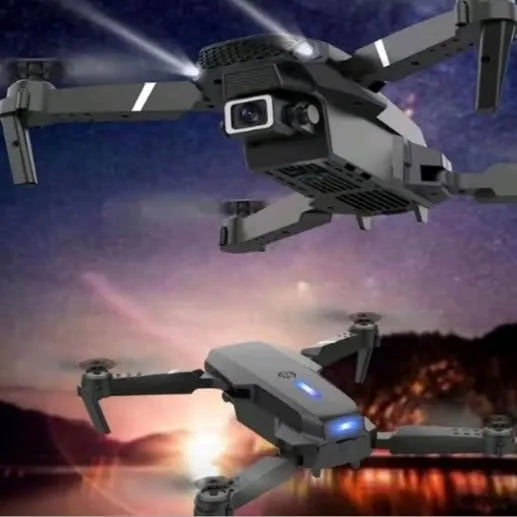 Gray quadcopter drone with front camera and spinning propellers, dual blue lights