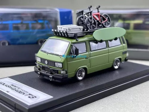 Green VW T3 camper van diecast toy with bicycle on roof rack, front view