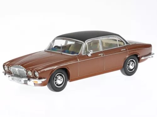 Brown diecast model car with white roof, chrome grille, and black wheels