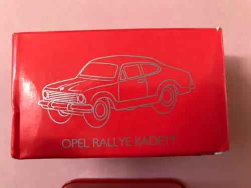 Boxed diecast rally car model with red packaging, car line art, and Opel Rallye Kadett text