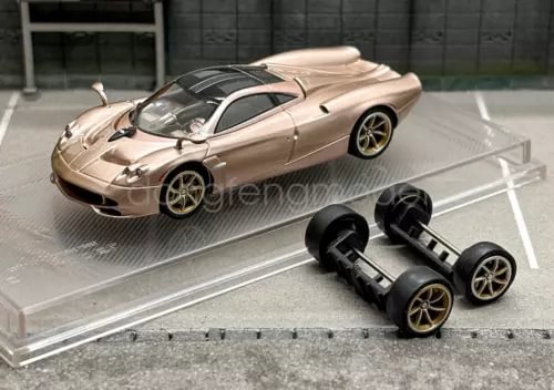 1:64 scale gold Huayra Codalunga racing sports diecast car on clear display stand