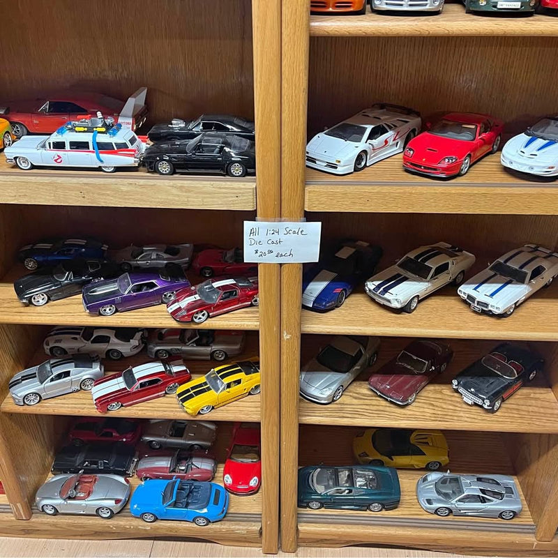 Row of diecast model cars in assorted colors on display