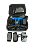 Drone accessory kit in open case with controller, batteries, charger, and beacon