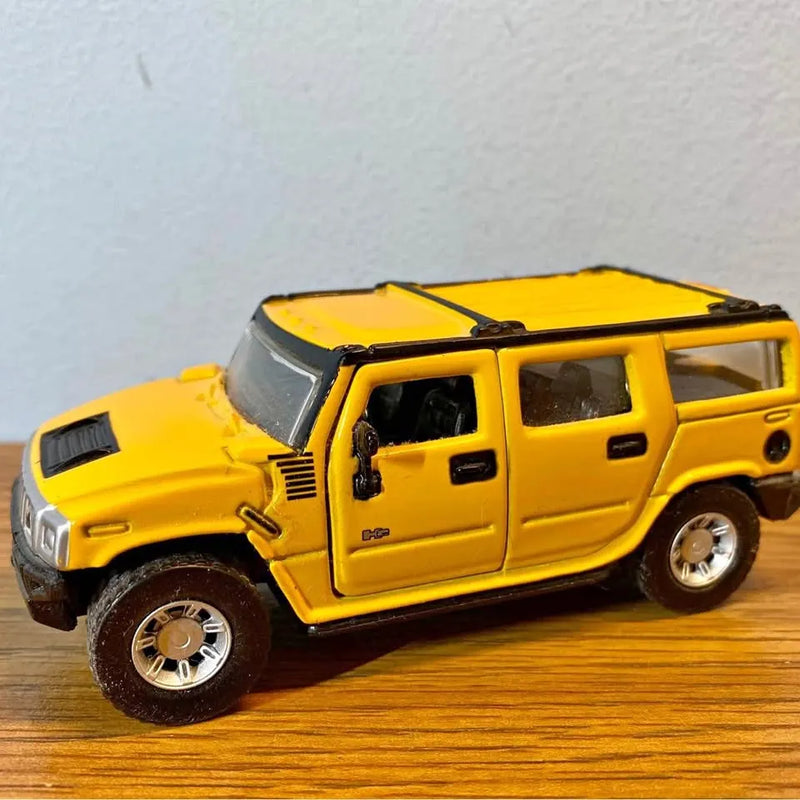 Yellow diecast Hummer SUV model, black hood, chrome wheels, 1:46 scale